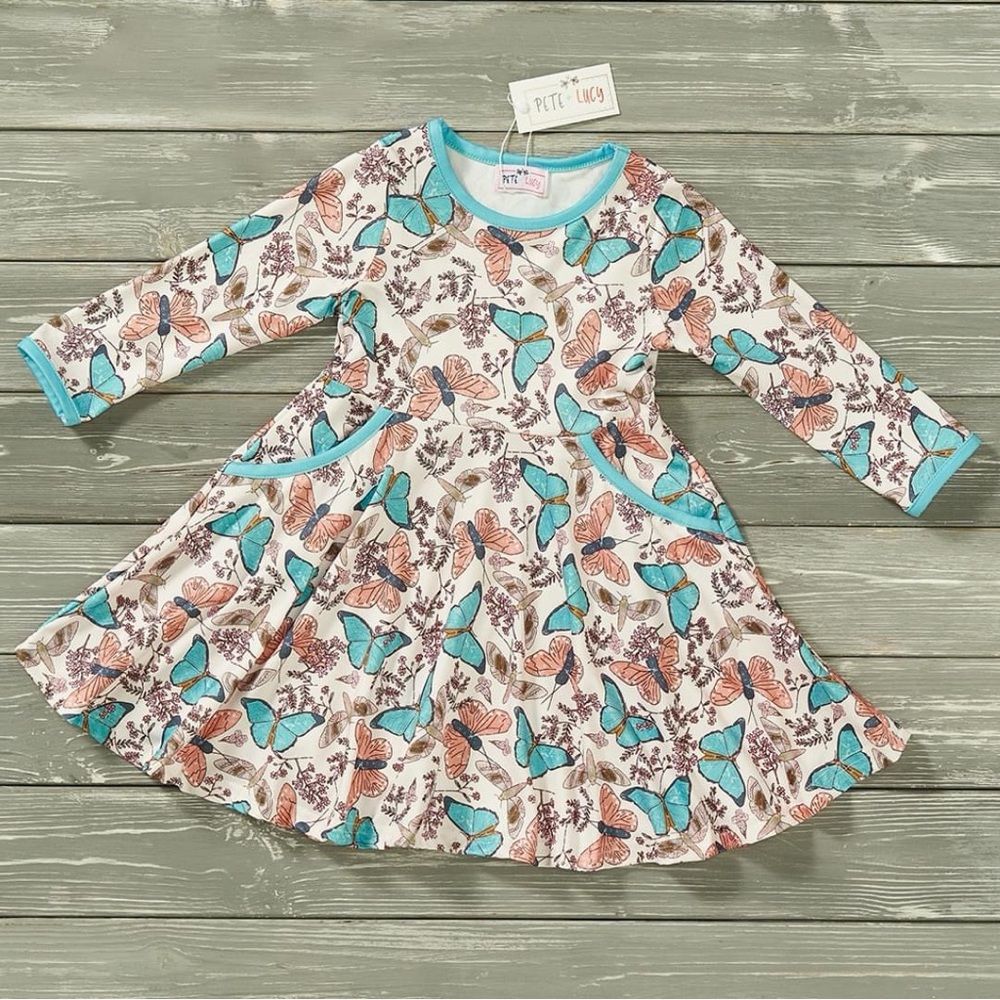 Girls toddler sizes long sleeve butterfly print dress with pockets. Tan and blue